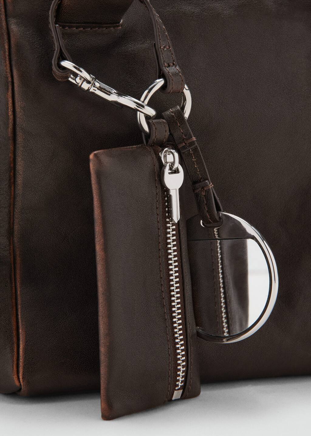 Leather clutch bag with charms