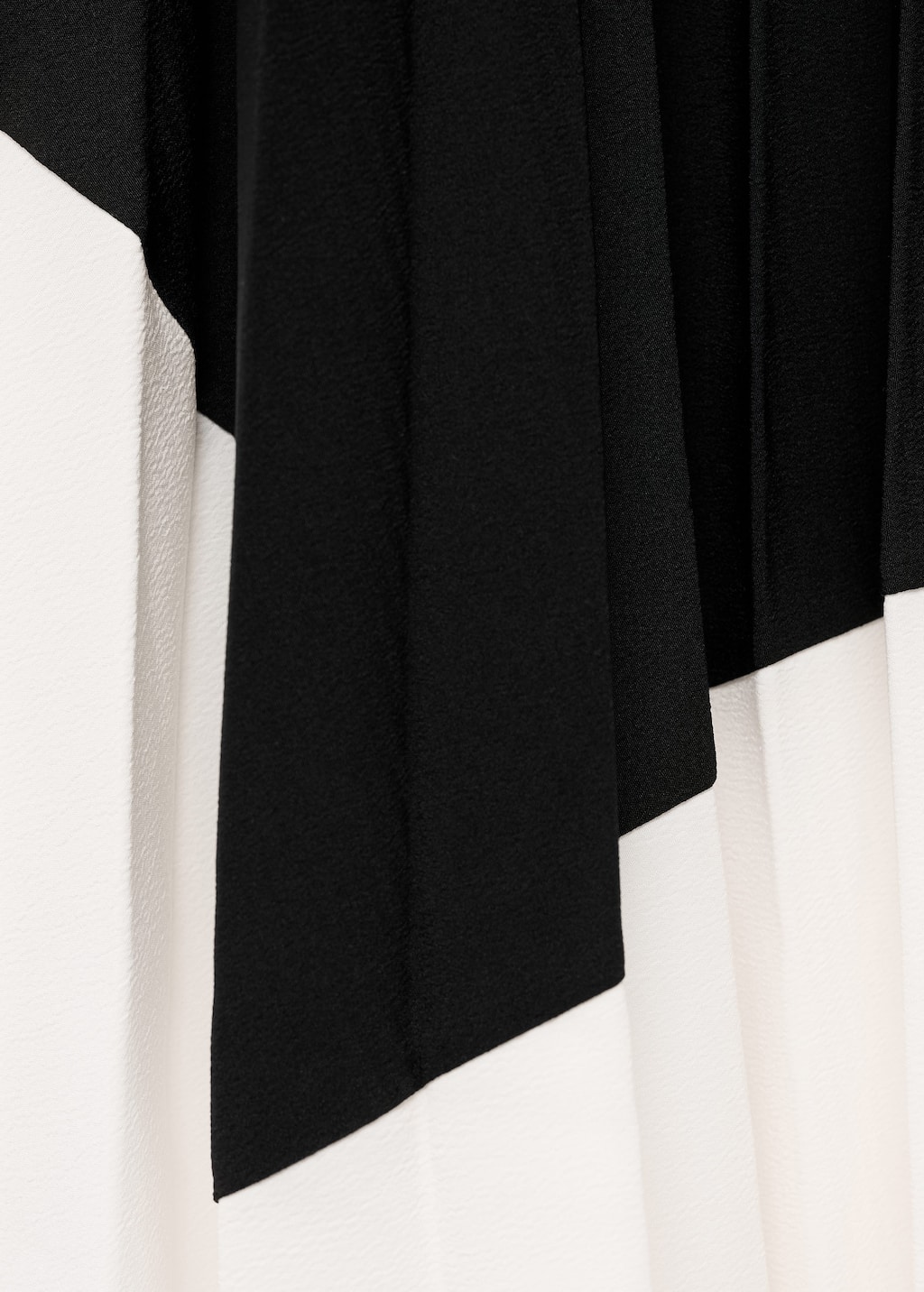 Pleated asymmetric skirt