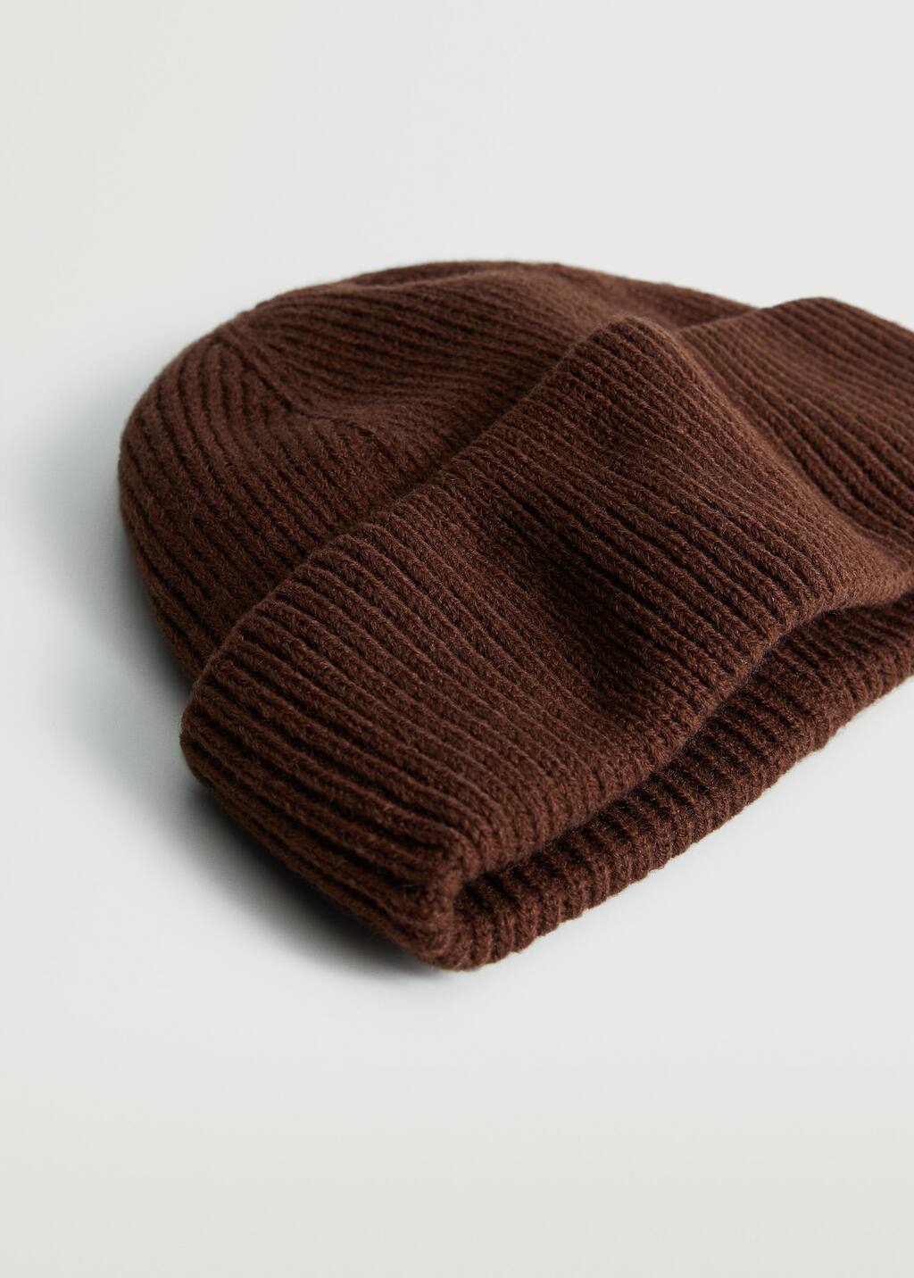 Mango Short knitted hat. a close-up of a brown hat on a white surface. 