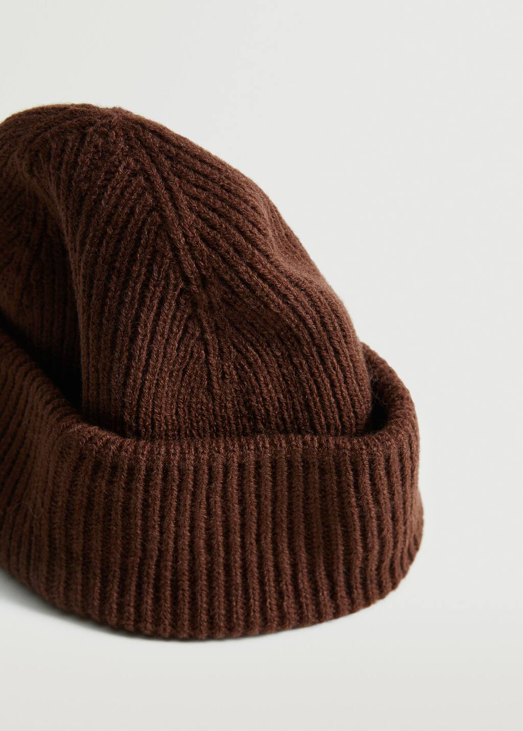 Mango Short knitted hat. a close-up of a brown hat on a table. 