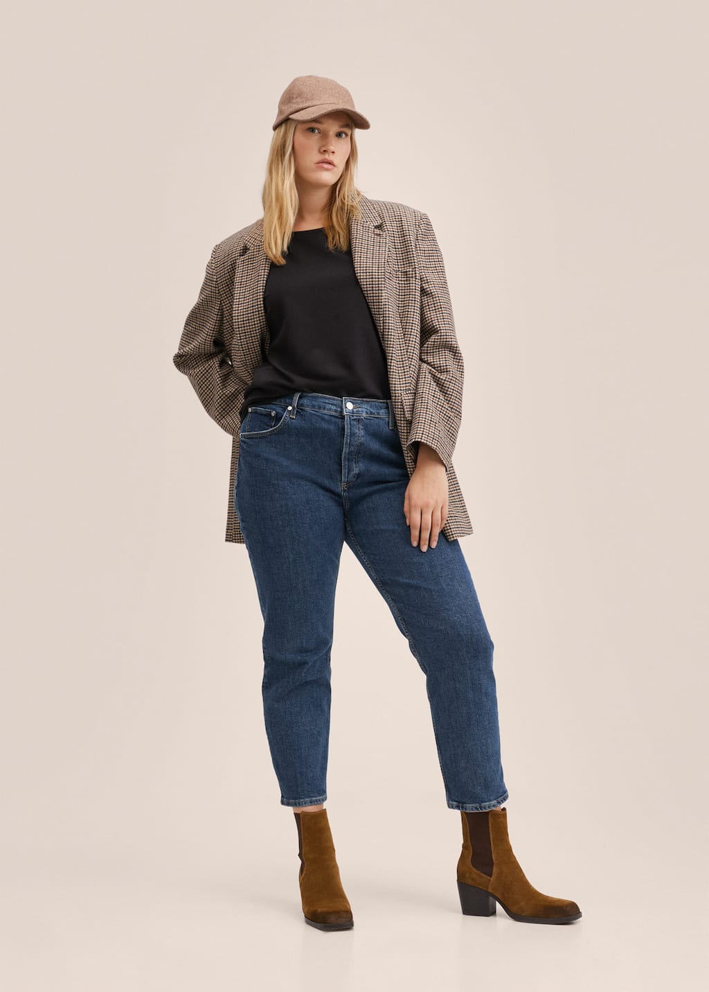 Mango Medium-waist cropped slim-fit jeans. a woman in a brown jacket and blue jeans. 