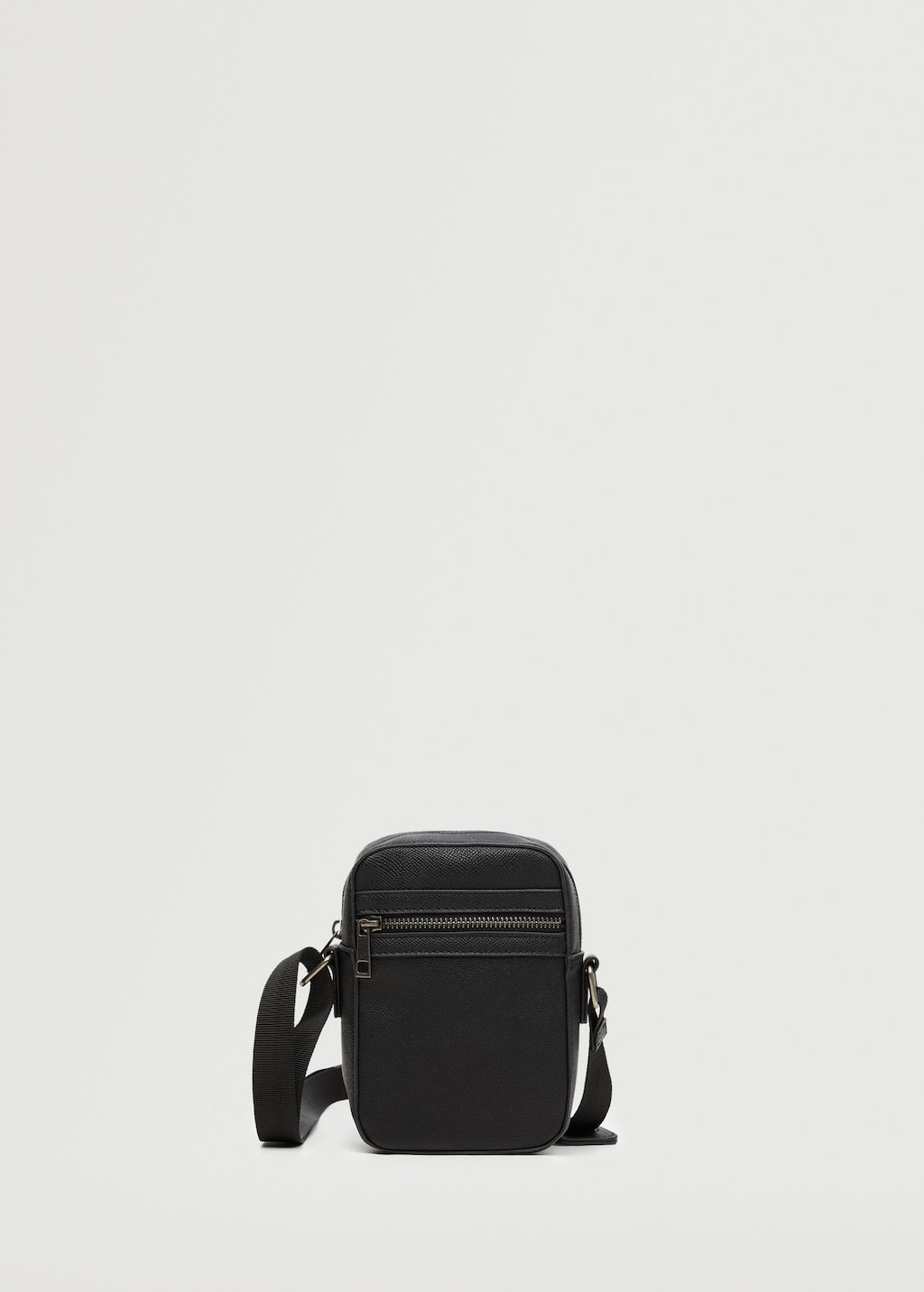 Mango Pebbled shoulder bag. a black bag is sitting against a white wall. 