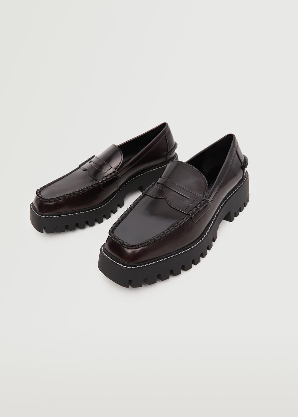 Dark Brown PU Loafers with round toe and track sole and white contrast stitching.