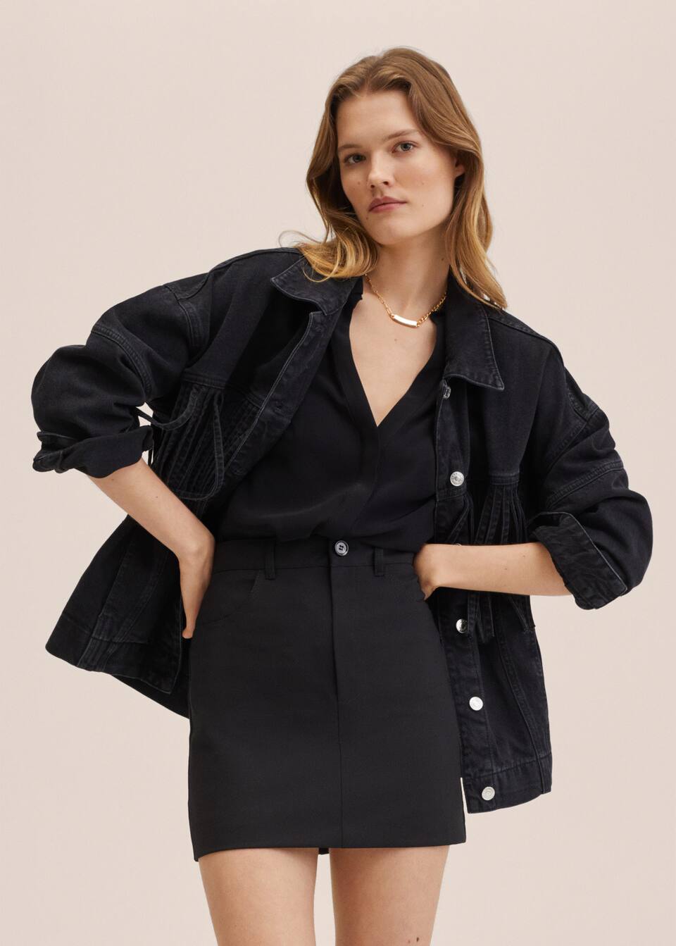 Oversized washed black denim jacket with western inspired fringed detailing. Classic button front fastening and cuffs.