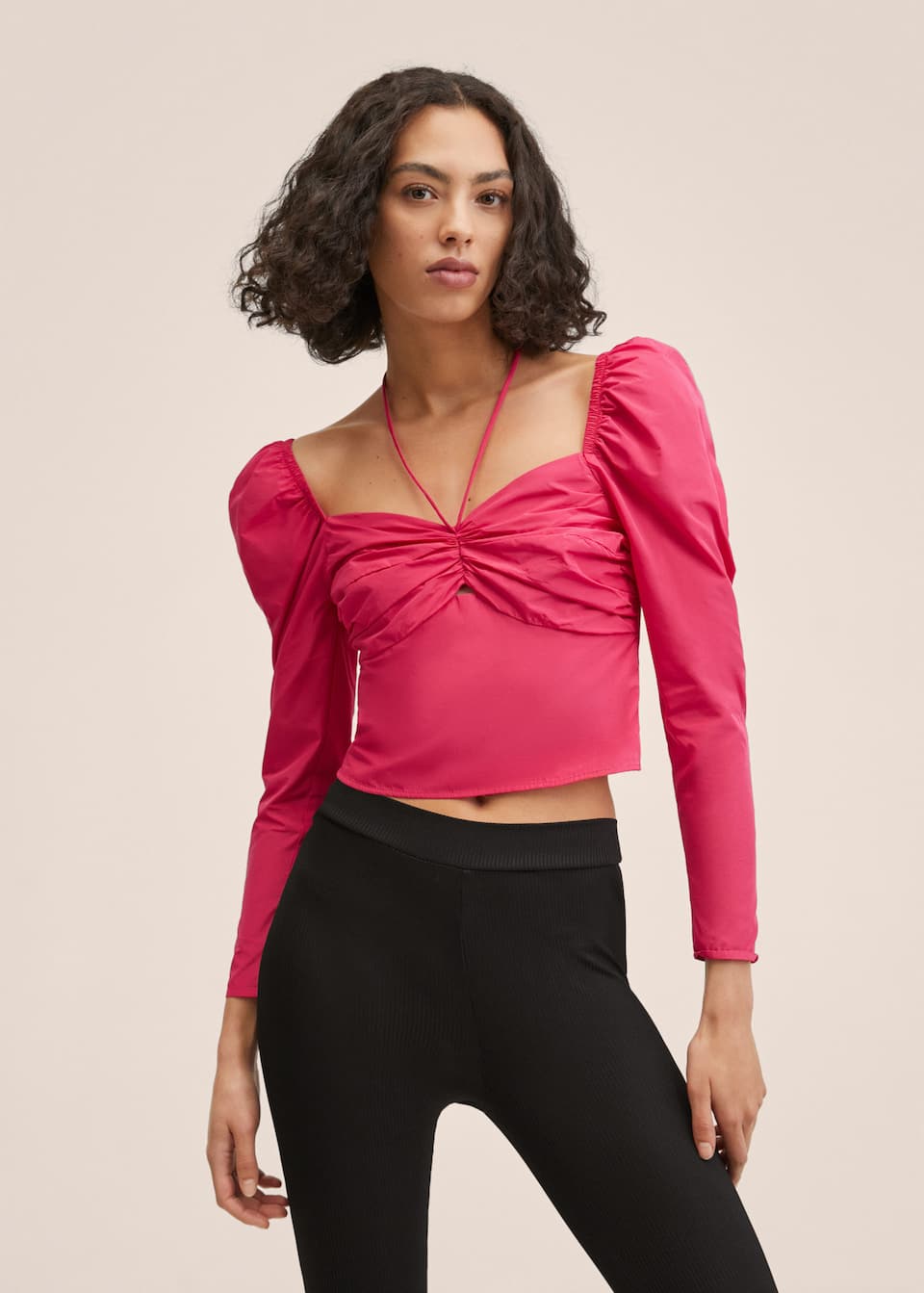 Bright pink cropped blouse with Long sleeves with puffed shoulders. Runched detail in the neckline with adjustable Bow at the neck. Inner lining. Side zip fastening.