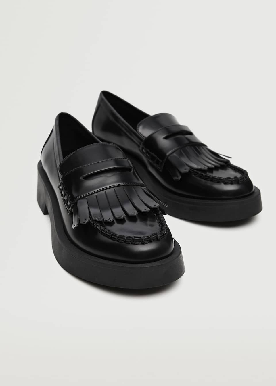 Black patent finish round toe, track sole loafers with fringe detail.