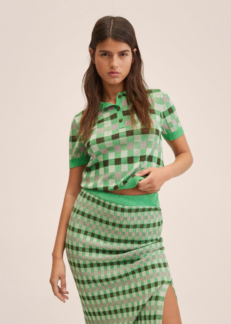 Mango Committed Collection. Fine lurex knit, cropped polo top with short sleeves and Green checked print. Coordinated with matching fitted midi knit skirt with slit.