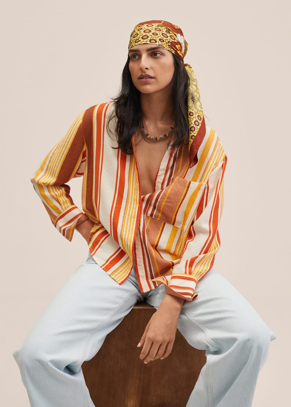 Mango Committed Collection multicolored striped shirt on burnt orange, yellow, red, and cream tones. Straight oversized design. Shirt-style collar with hidden button placket. Long sleeve with buttoned cuffs. Patch pocket on the chest.