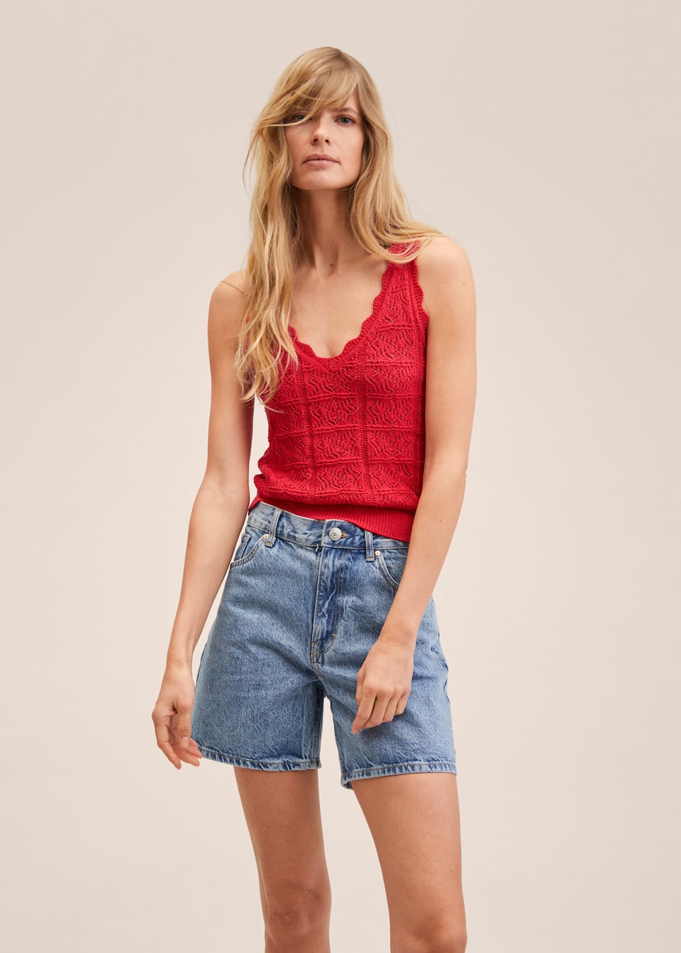 Red fine openwork sleeveless knit top with v-neck scalloped edges and ribbed bottom.