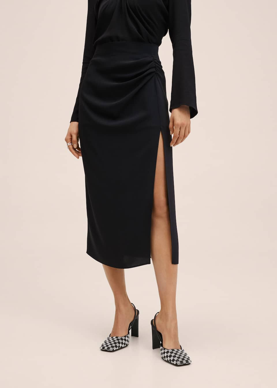 Black midi length slim fitting skirt with a slit over the leg and draped ruching effect at the hip.