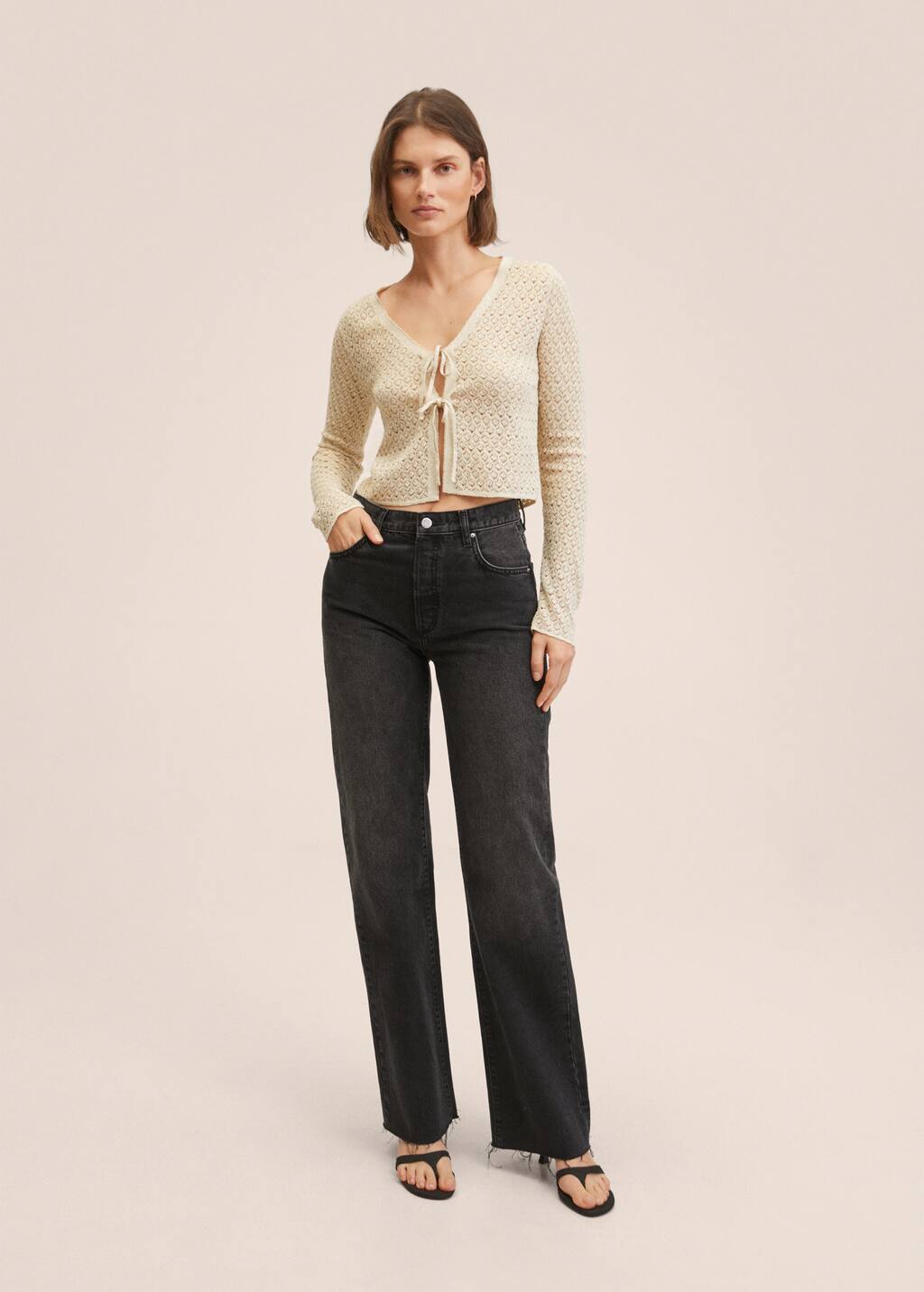 Mango Lurex knitted cardigan. a woman in a white sweater and black jeans. 