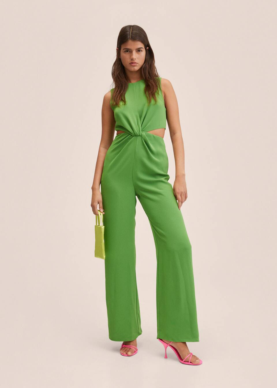 Mango Committed Collection, full length green jumpsuit with straight legs, round neck and sleeveless design. Twisted knot feature in the centre with 2 small cut outs on each side at the waist. Invisible zip closure at the back.