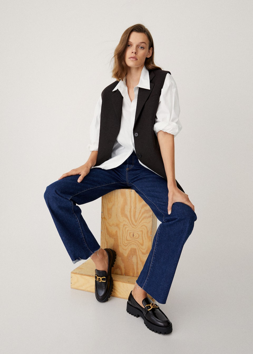 Faux Leather black loafers with a track sold and gold decorative chain.