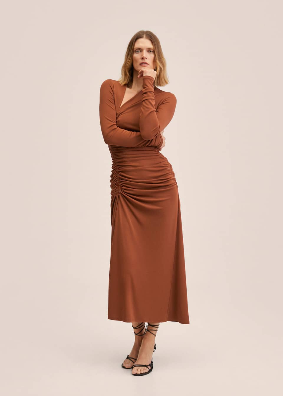 Brown Gathered dress in a Tailored design with Adjustable Central gathered section detail. Slit detail over the leg, Asymmetric neckline and Long ruched sleeves.