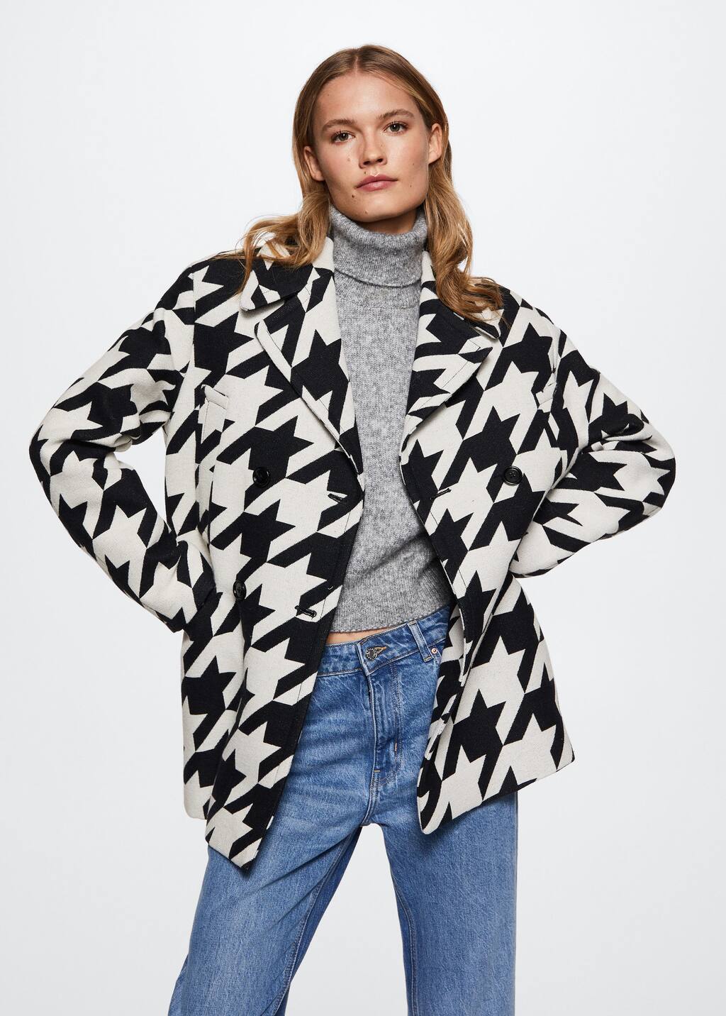 Mango Buttoned cotton coat. a woman wearing a black and white jacket. 