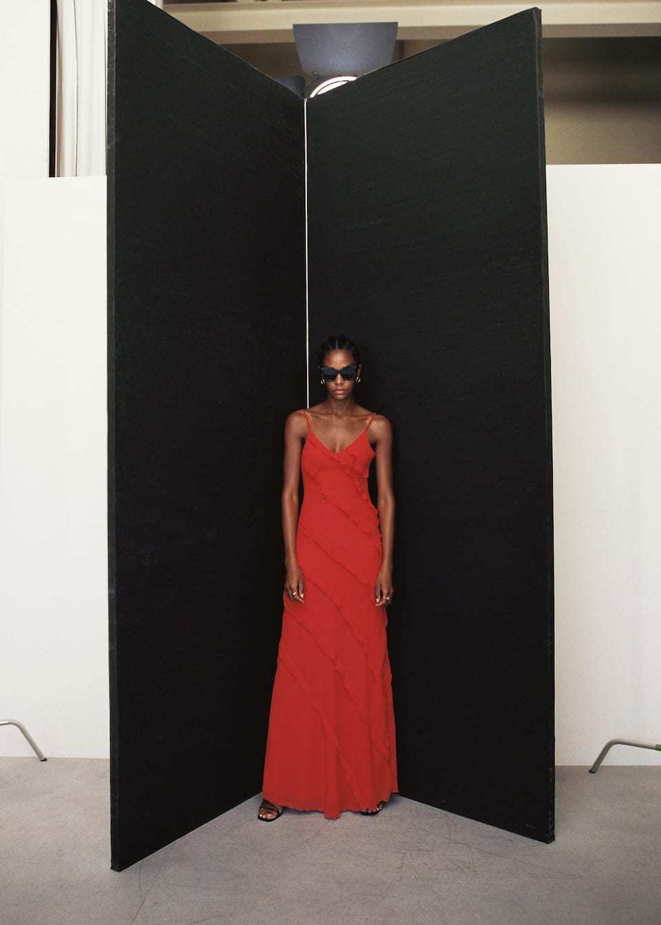 This Mango red chiffon ruffle maxi dress is guaranteed to turn heads at your next party or event. It has sphagetti trsaps, a v neck lineand is bias cut with a floor sweeping maxi length. It is made from a light, chiffon fabric, gauze fabric. It features subtle ruffles that twirl diagonally around the dress from top to bottom. It has an inner lining and side zip. It has a subtly low back.