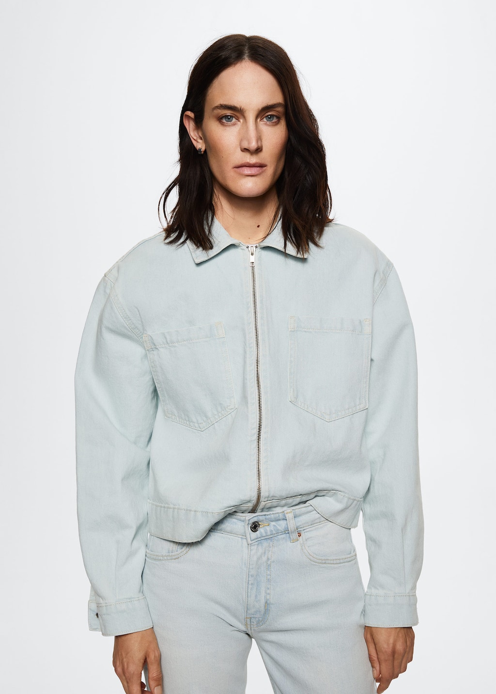 Mango Pockets denim jacket. a person wearing a light blue jacket. 