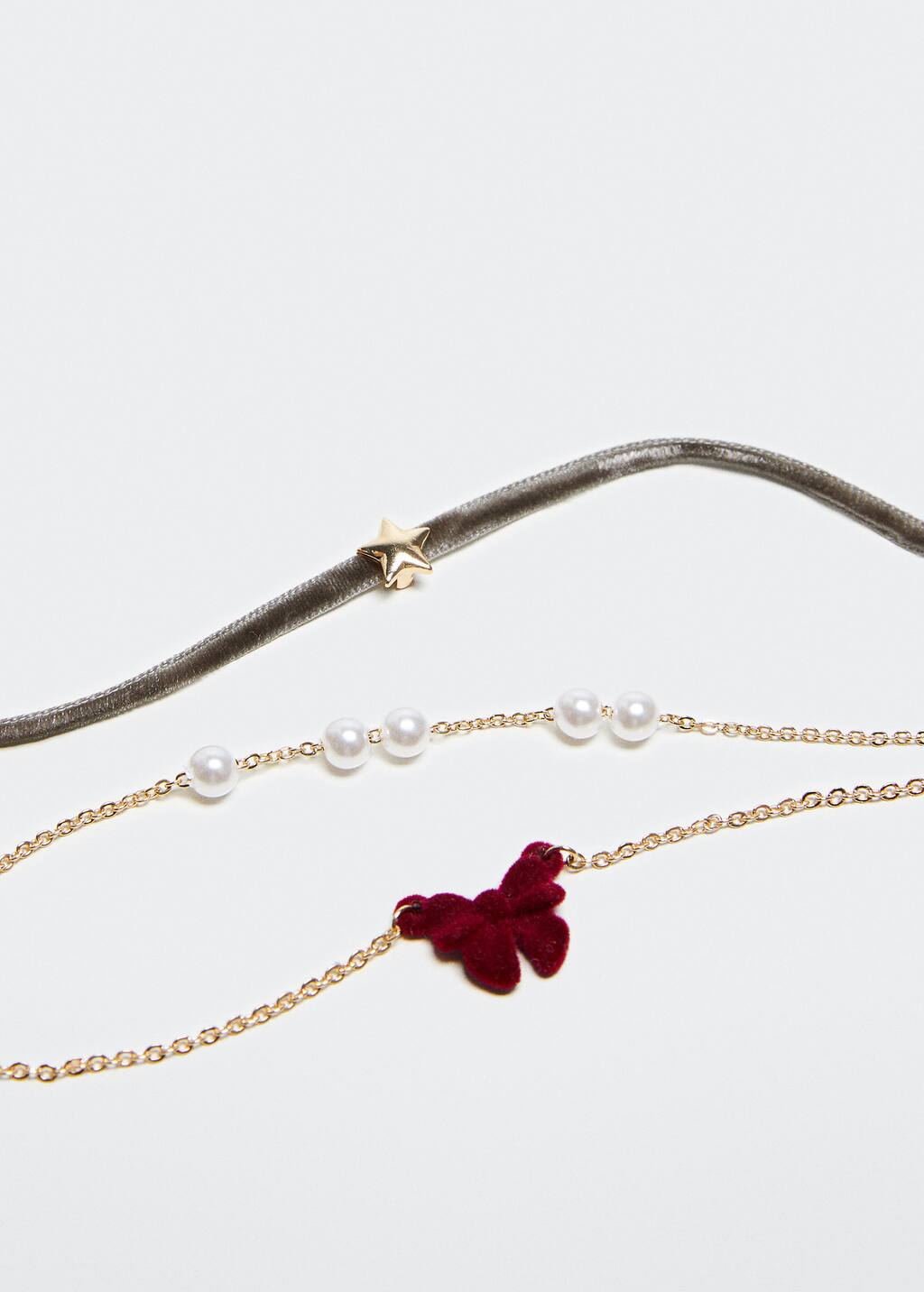 Mango Pack of 3 Christmas bracelets. a close up of a necklace with a butterfly Mango Pack of 3 Christmas bracelets. a close up of a necklace with a butterfly