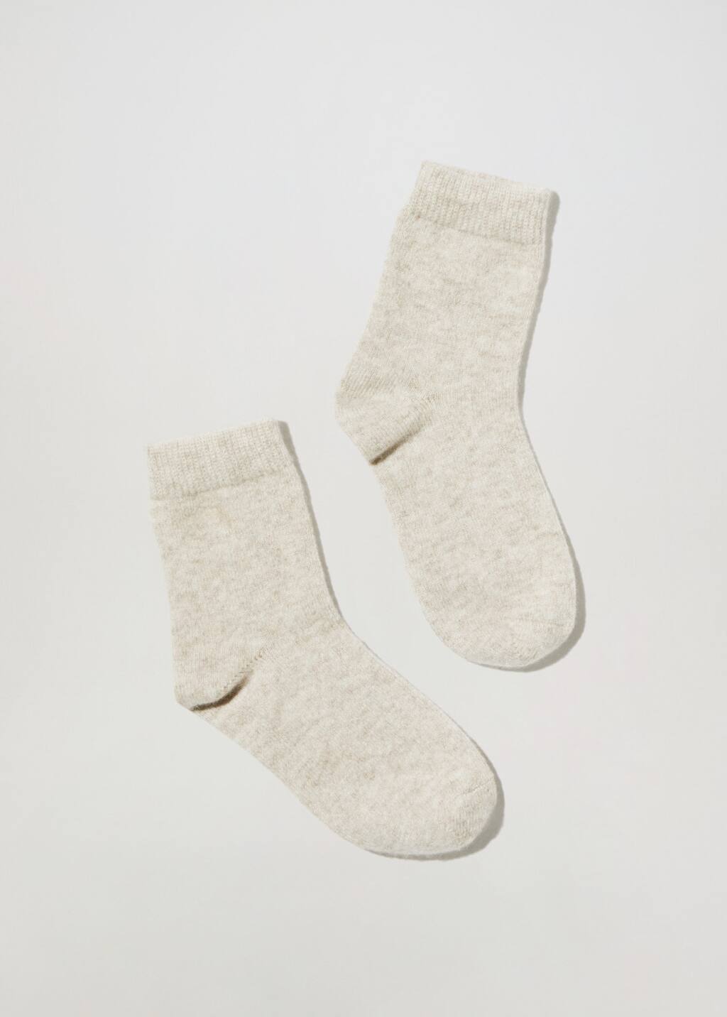 Mango Cashmere knitted socks. a pair of white socks on a white background. 