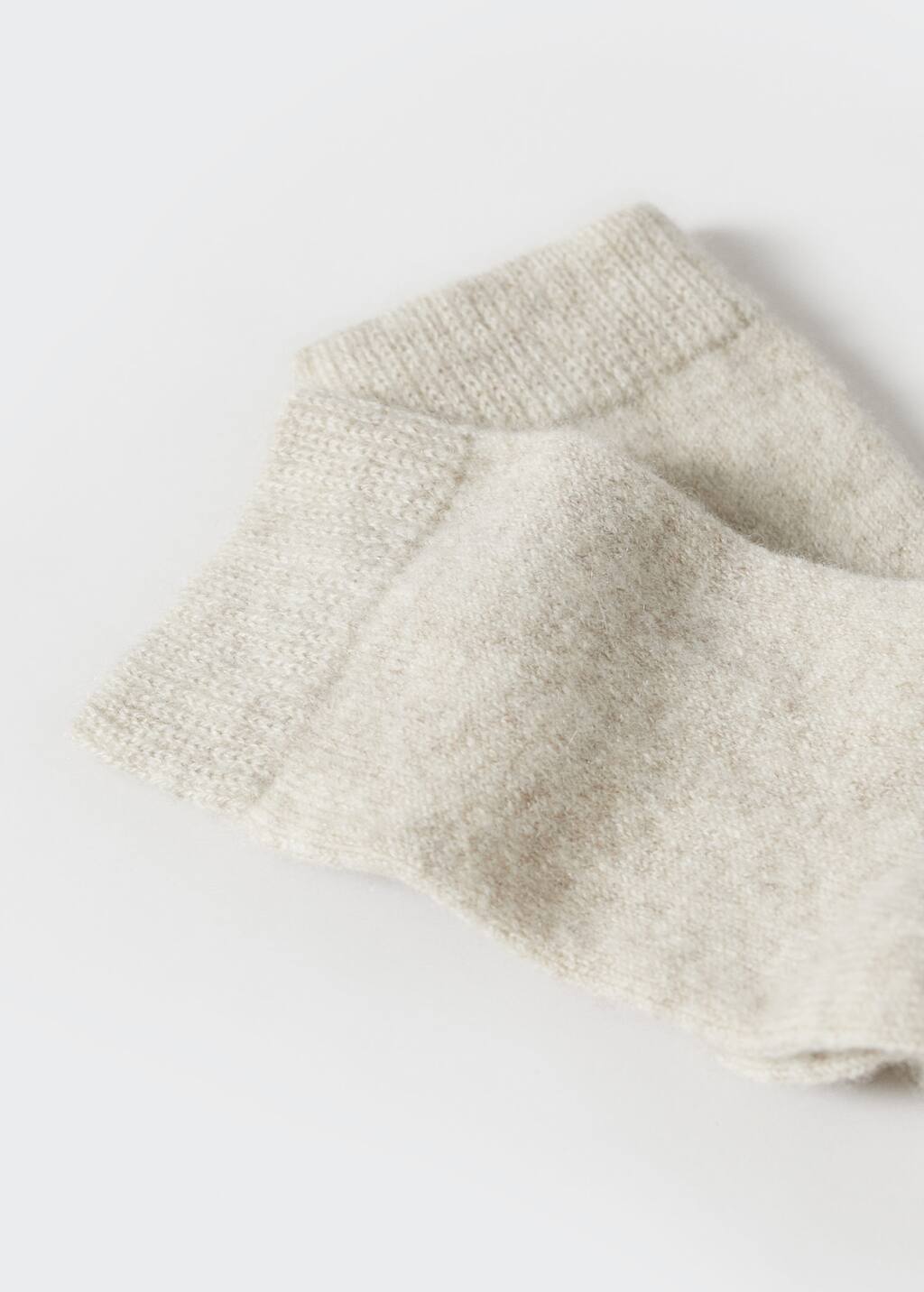 Mango Cashmere knitted socks. a close up of a pair of socks on a table 