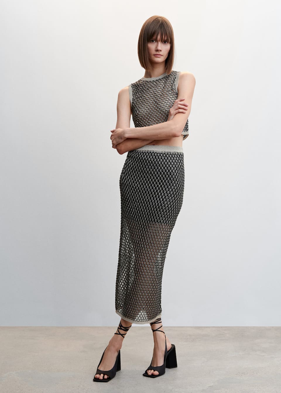 Mango Openwork knit fabric lurex top in gunmetal. This Cropped design top has a Rounded neck and is Sleeveless.