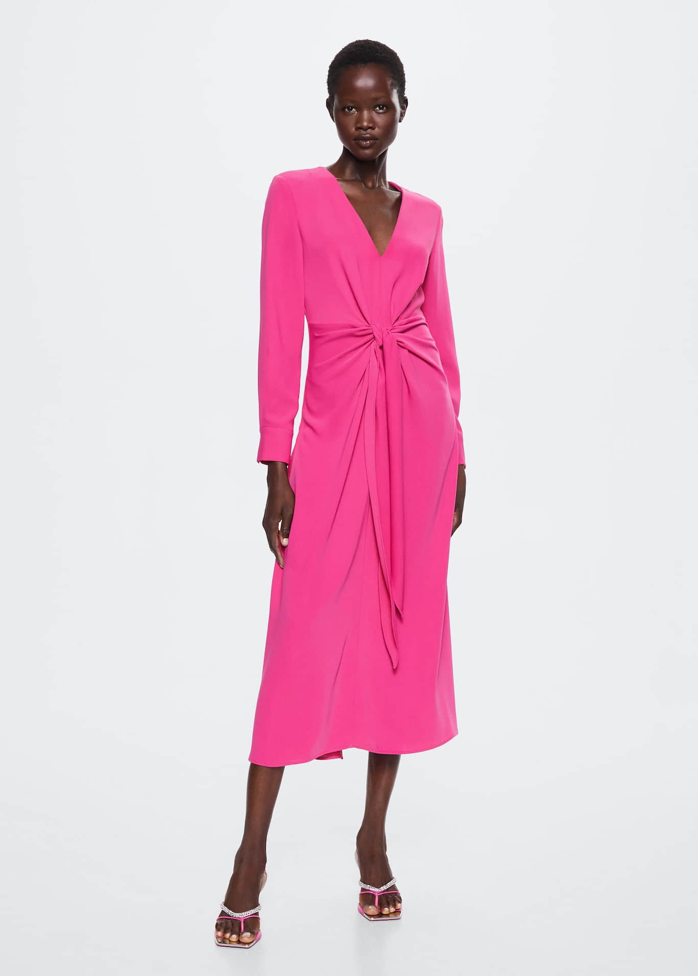 Mango pink midi dress with a cross over tie front with ruching detail. It comes in a pink flowy fabric and Straight design with a V-neck and Long buttoned sleeve.