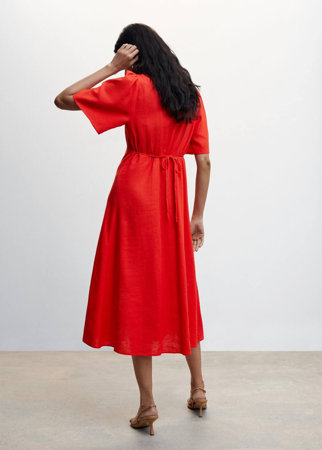 Mango Buttoned linen-blend dress. a woman wearing a red dress standing in a room. 