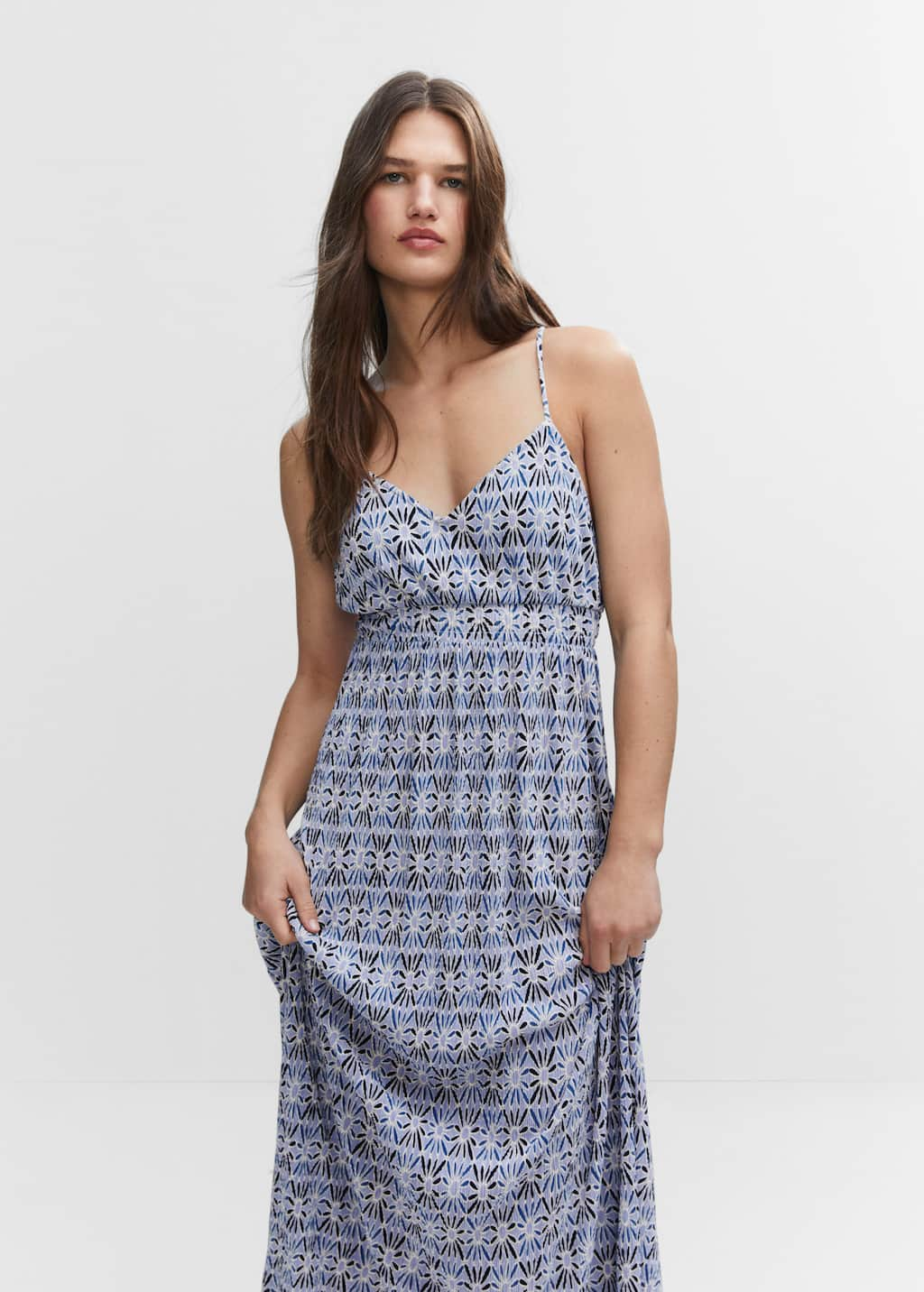 Mango Cross-back textured dress. a woman in a blue and white dress. 