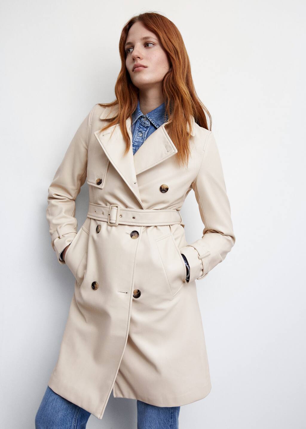 Mango Leather-effect trench coat. a woman wearing a white trench coat and jeans. 