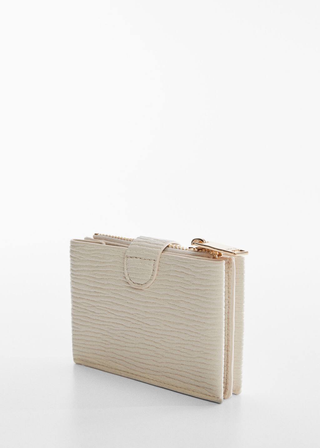 Mango Textured card holder with embossed logo. a white purse sitting on top of a table. Mango Textured card holder with embossed logo. a white purse sitting on top of a table.