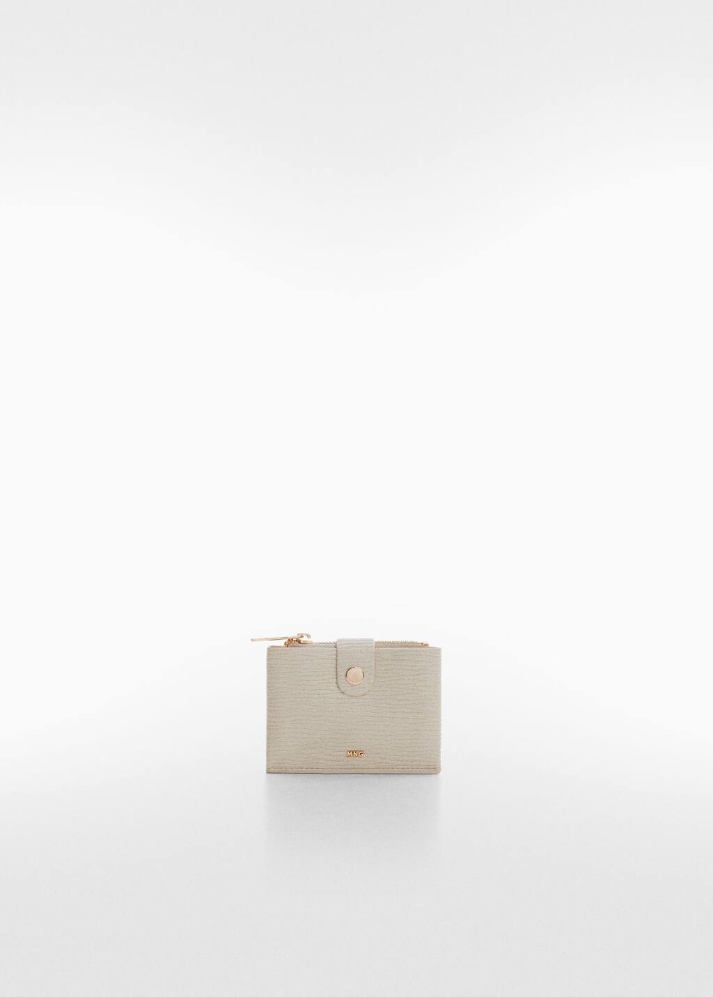 Mango Textured card holder with embossed logo. a white purse sitting on top of a white table. Mango Textured card holder with embossed logo. a white purse sitting on top of a white table.