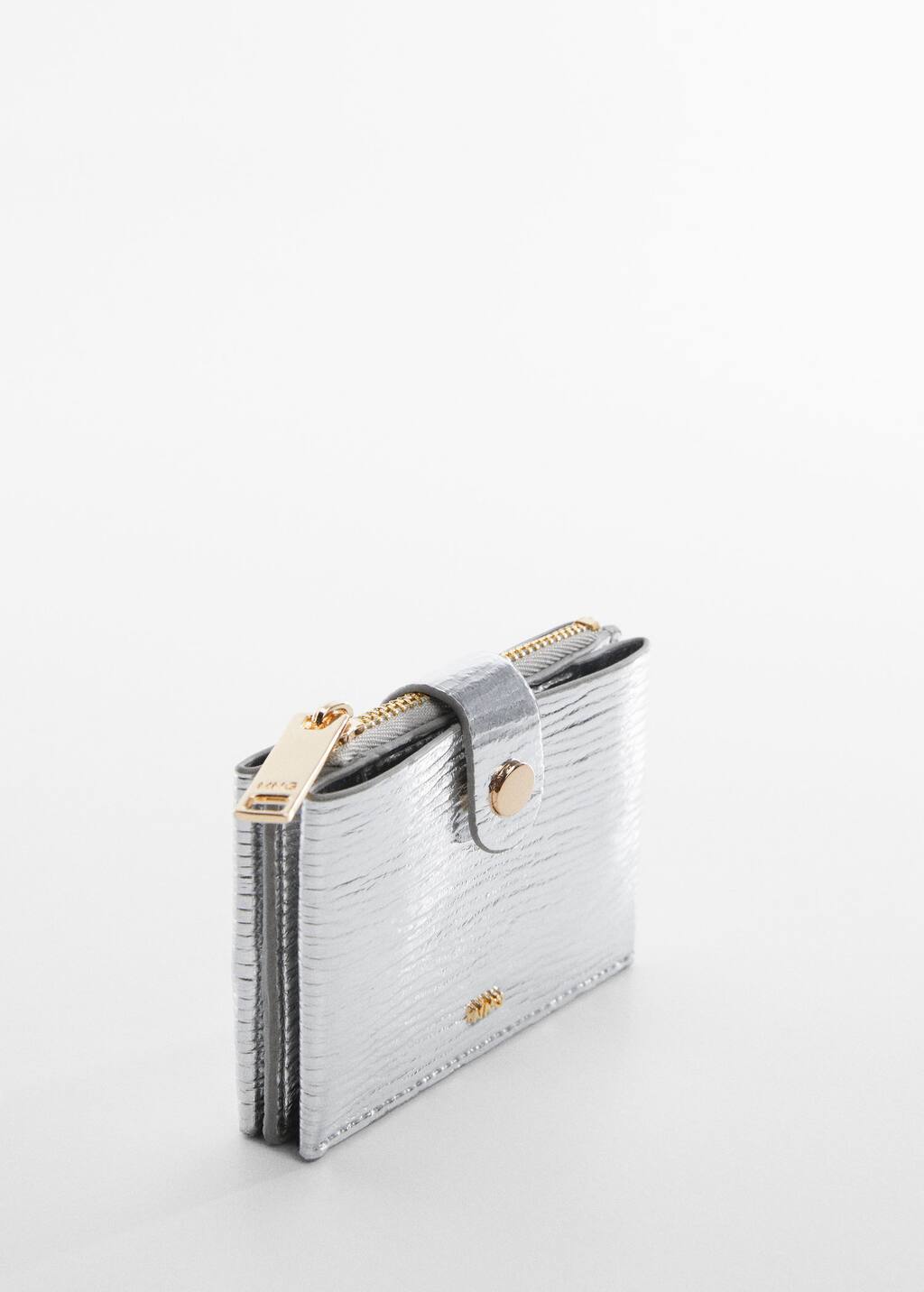 Mango Textured card holder with embossed logo. a close-up of a silver purse on a white surface. 