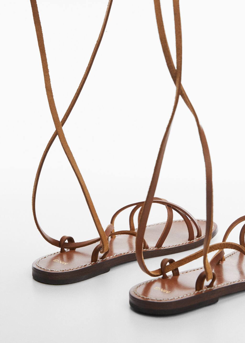 Mango Leather straps sandals. a close up of a pair of brown sandals. 