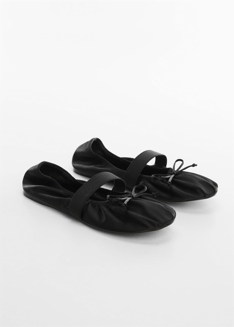 ballet flats in black Satin with a Leather sole and elastic over the foot. They have a Rounded toe and bow.