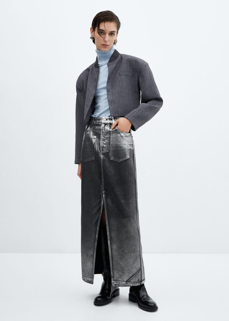 Mango silver foil denim maxi skirt.
Denim style cotton fabric, medium waist, straight design, metallic finish, zip and one button fastening, five pockets, opening in the lower front, loops.