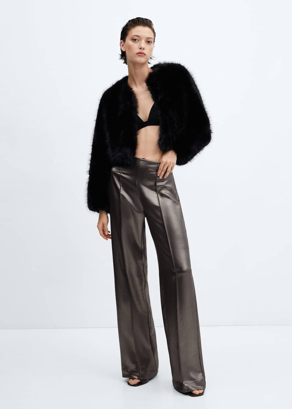 Mango metallic effect slinky trousers. DESCRIPTION
Flowy fabric. Wide-leg design. Metallic finish. Medium waist. Invisible side zip fastening. Decorative seams. Party and events collection.