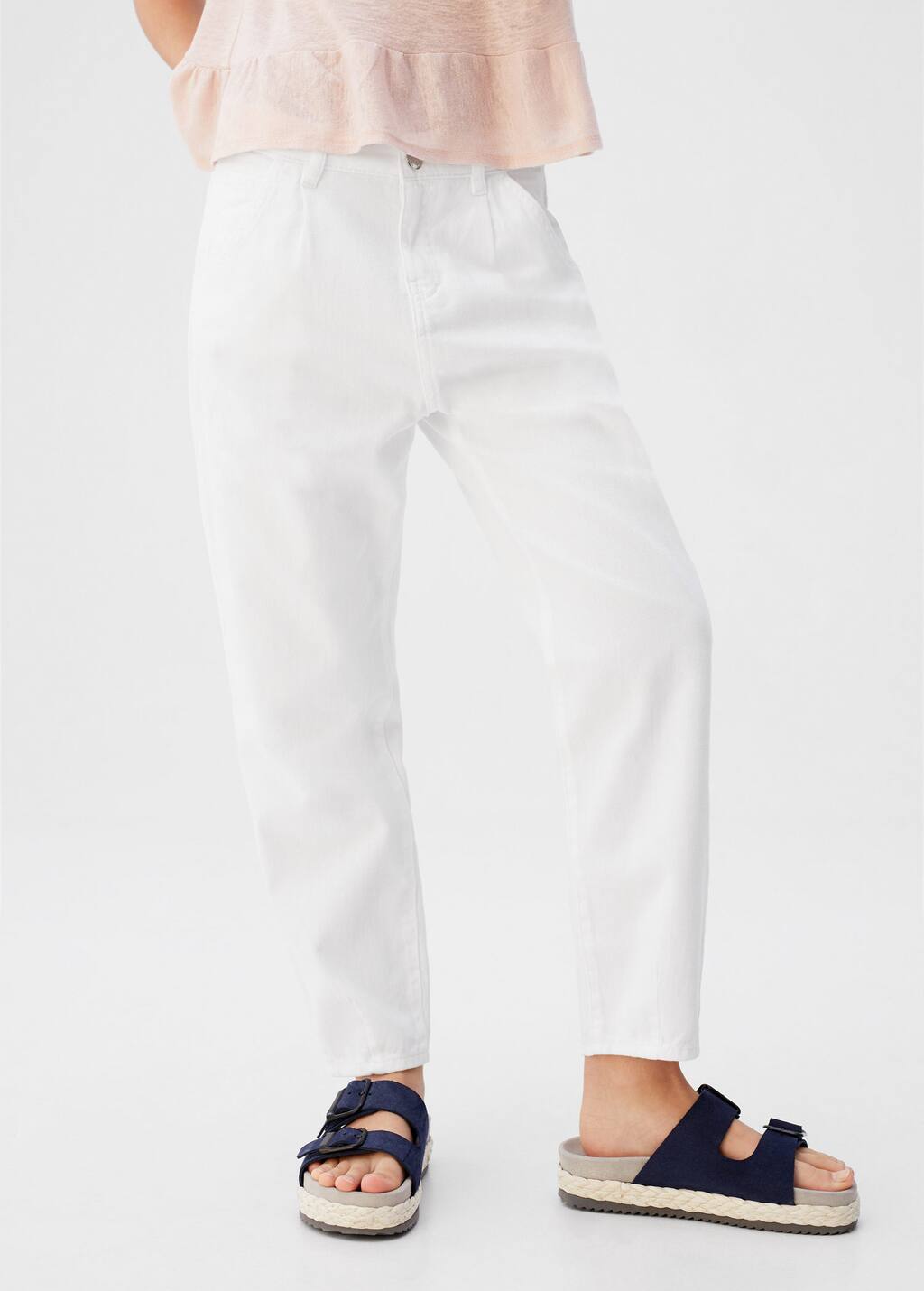 Mango White Slouchy jeans. a person wearing white pants standing next to a wall. 