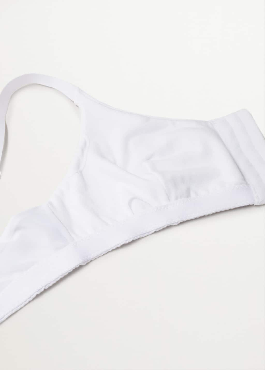 Mango Sport bra with adaptable cups . a close-up of a white bikini top. 