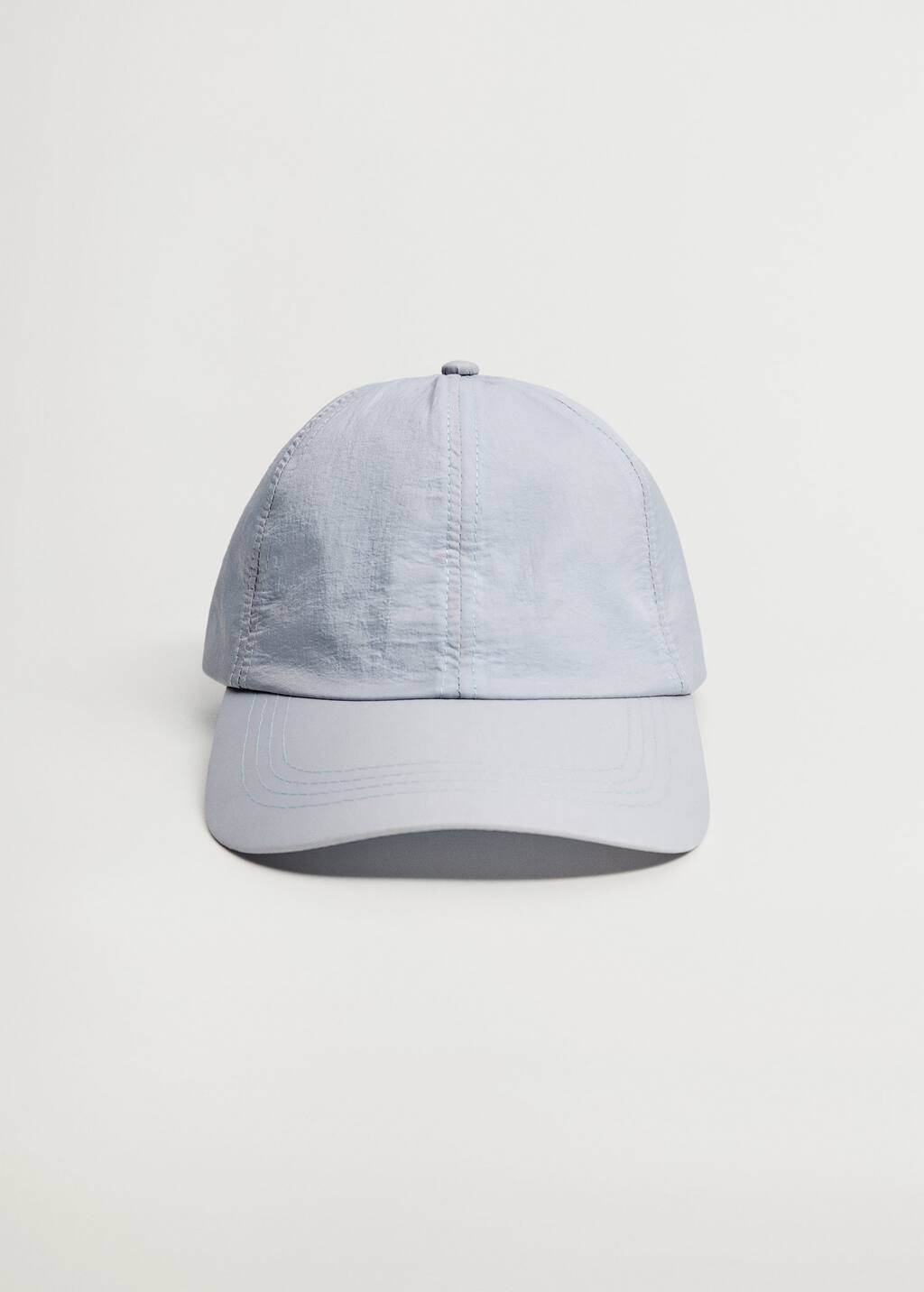 Mango Cap with visor. a light blue baseball cap on top of a white surface. 